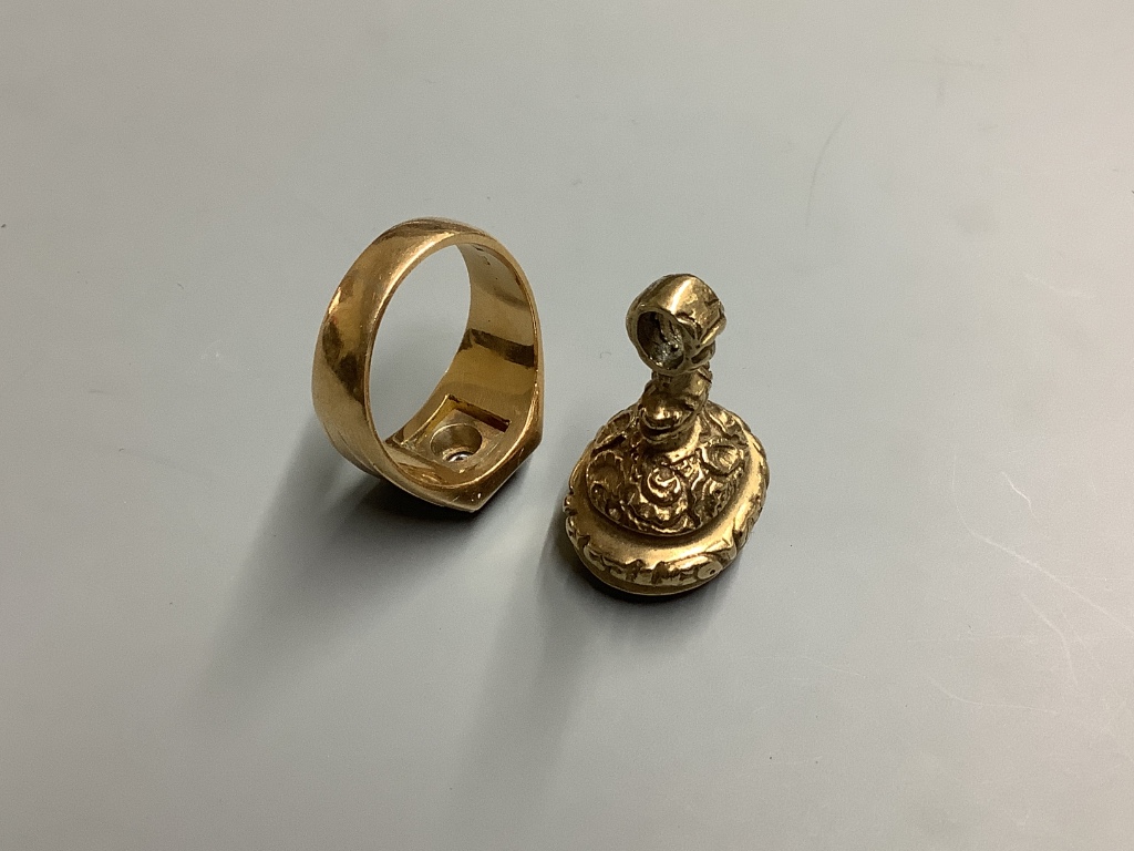A yellow metal and paste? set signet ring, size U/V, gross weight 14 .1 g, together with a yellow metal overlaid and black onyx fob seal.